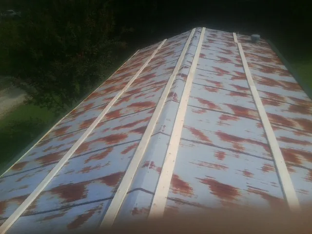Rusted metal roof panels with new wood purlins before replacement — Storm Damage Roof Repair in Iota by Roofing Brothers